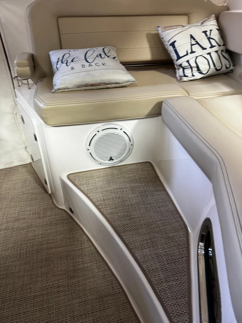 Slide: The Image of 2018 Pursuit OS 355 Offshore interior with beige seating and decorative pillows. - 10