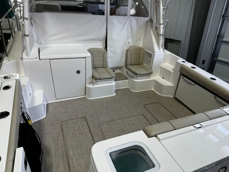 Slide: The Image of 2018 Pursuit OS 355 Offshore boat interior with seating and storage compartments. - 11