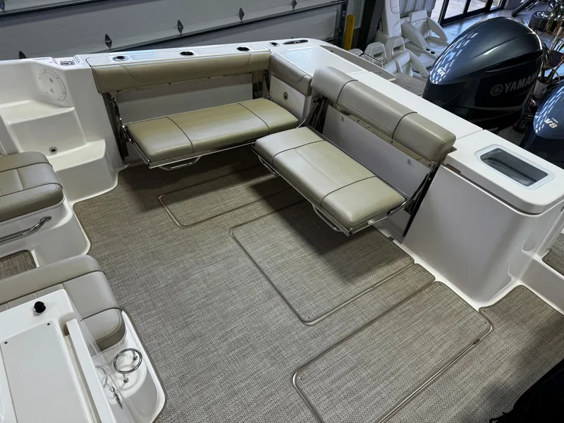 Slide: The Image of 2018 Pursuit OS 355 Offshore boat interior with foldable seating and Yamaha engines. - 15