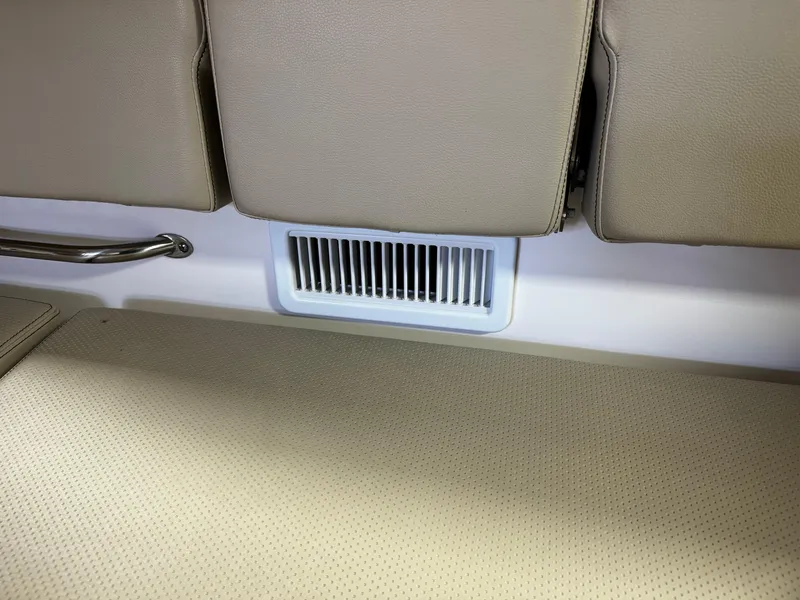 Slide: The Image of 2018 Pursuit OS 355 Offshore interior with beige seating and air vent. - 17