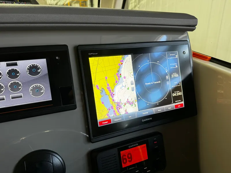 Slide: The Image of Dashboard of a 2018 Pursuit OS 355 Offshore with Garmin navigation display. - 18