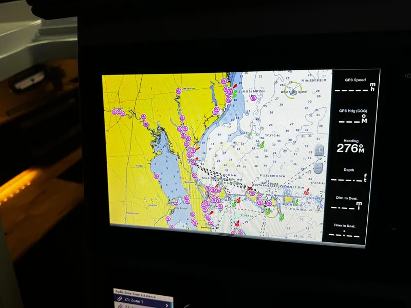 Slide: The Image of 2018 Pursuit OS 355 Offshore navigation screen displaying nautical chart and GPS data. - 19