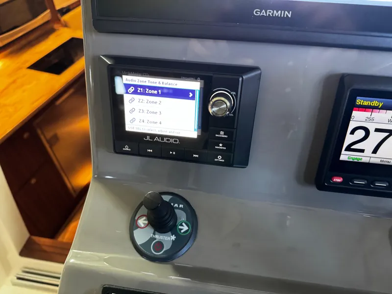 Slide: The Image of Control panel of 2018 Pursuit OS 355 Offshore boat with JL Audio and Garmin displays. - 24