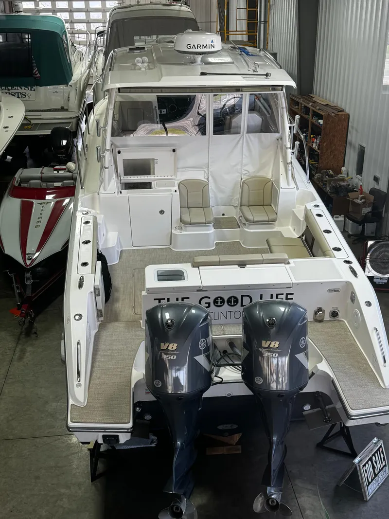 Slide: The Image of 2018 Pursuit OS 355 Offshore boat with twin V8 engines in a storage facility. - 3