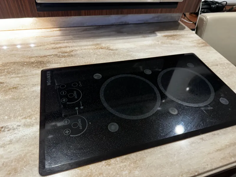 Slide: The Image of Modern induction cooktop on a Pursuit OS 355 Offshore 2018 yacht kitchen counter. - 31