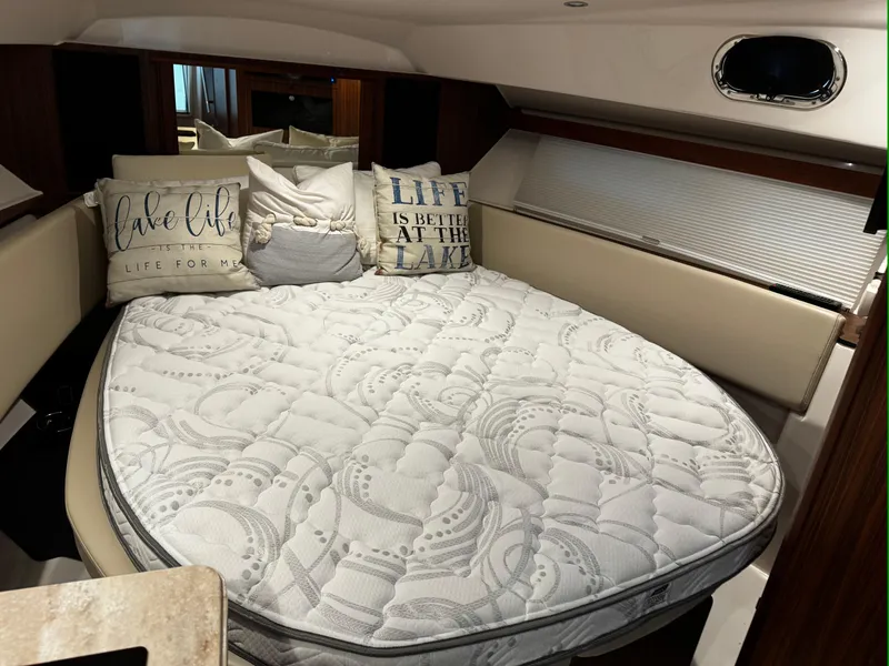 Slide: The Image of 2018 Pursuit OS 355 Offshore cabin with cozy bed and decorative pillows. - 33