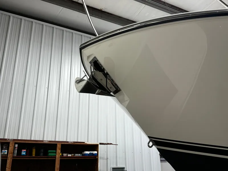 Slide: The Image of 2018 Pursuit OS 355 Offshore boat in storage, showcasing sleek hull design. - 4
