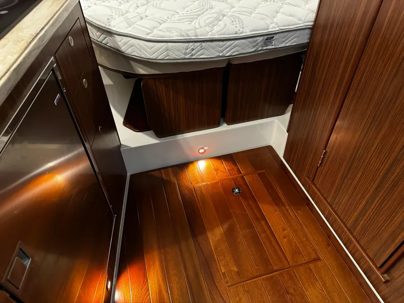 Slide: The Image of 2018 Pursuit OS 355 Offshore cabin interior with wood flooring and bed. - 40