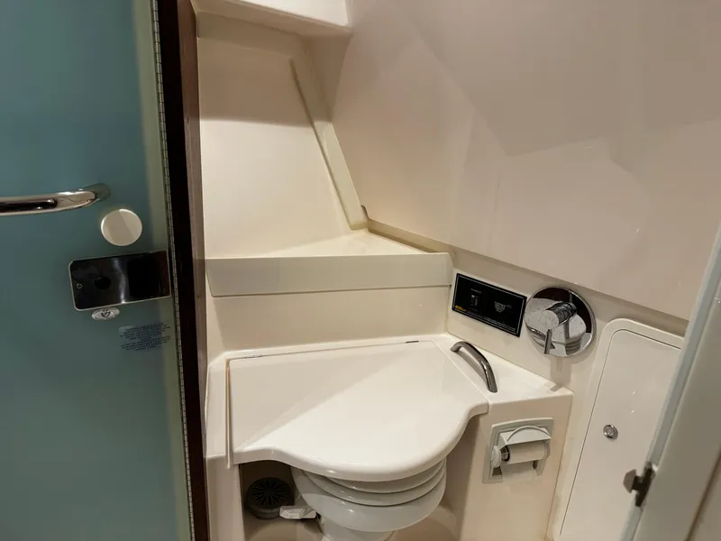 Slide: The Image of 2018 Pursuit OS 355 Offshore boat bathroom with compact toilet and modern fixtures. - 43