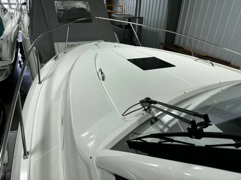 Slide: The Image of 2018 Pursuit OS 355 Offshore boat deck in storage, showcasing sleek design and railing. - 44