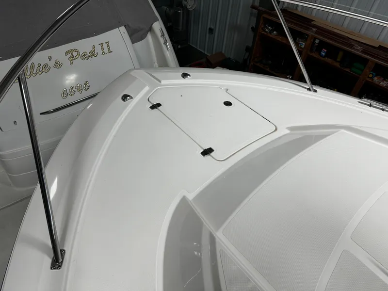 Slide: The Image of 2018 Pursuit OS 355 Offshore boat deck with storage hatch and railing. - 45