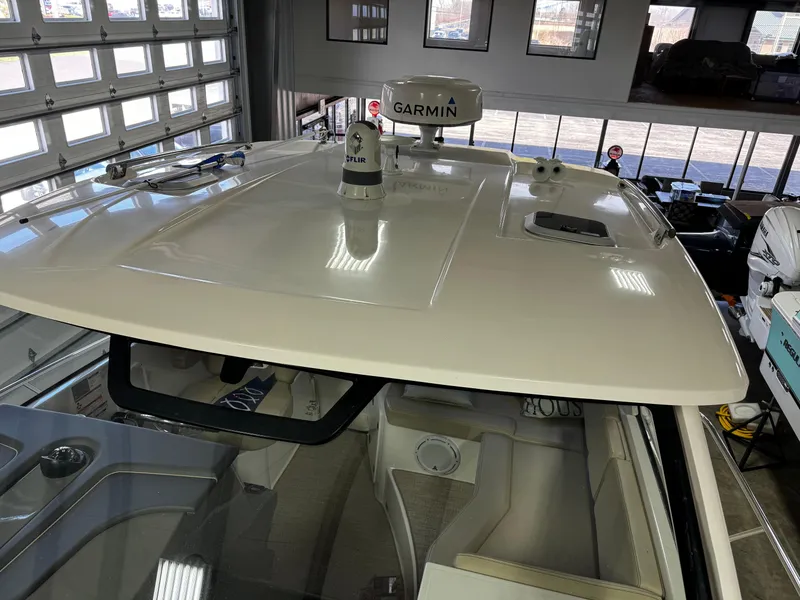 Slide: The Image of 2018 Pursuit OS 355 Offshore boat with Garmin radar, interior view in a showroom. - 47