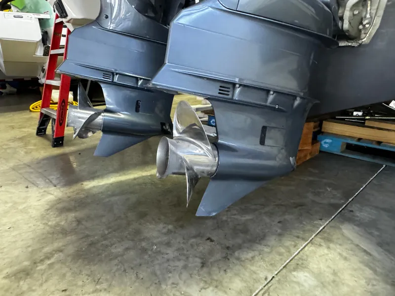 Slide: The Image of 2018 Pursuit OS 355 Offshore boat propellers in a garage setting. - 8