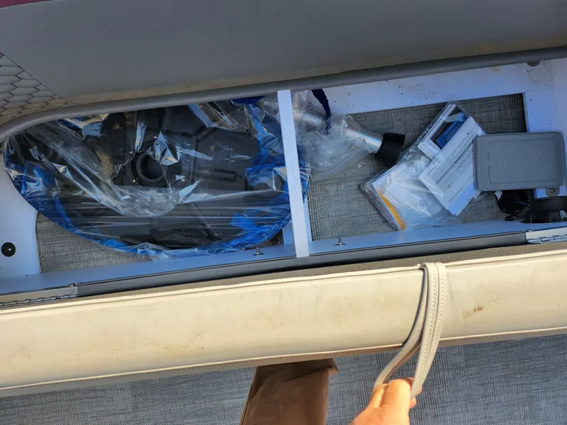 Slide: The Image of 2024 Qwest Angler Qwest XRE storage compartment with equipment and documents. - 13