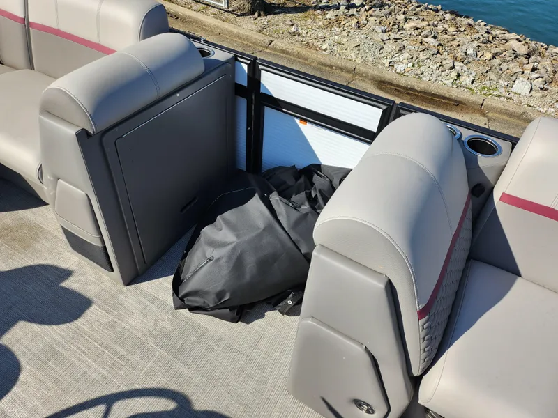 Slide: The Image of 2024 Qwest Angler Qwest XRE boat interior with gray seating and storage area. - 14