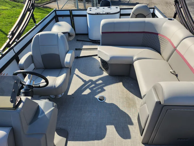 Slide: The Image of 2024 Qwest Angler Qwest XRE pontoon boat interior with plush seating and steering console. - 15
