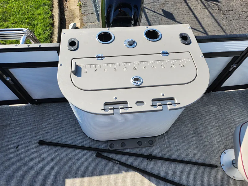 Slide: The Image of 2024 Qwest Angler Qwest XRE boat console with built-in measuring tool and cup holders. - 17