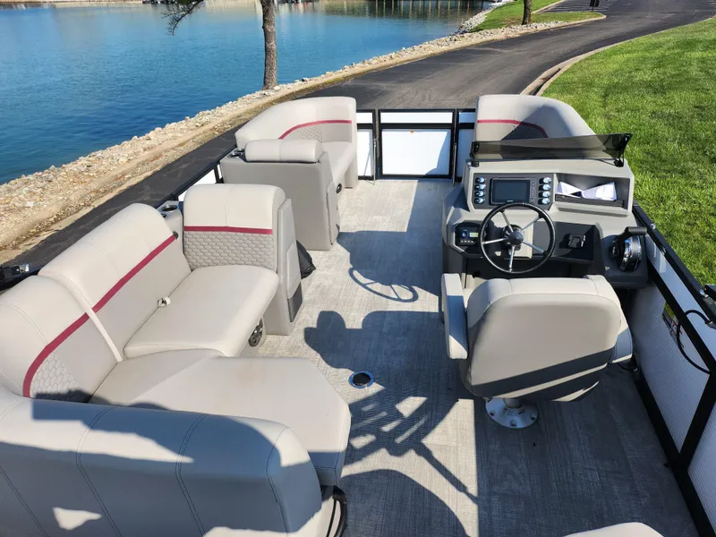 Slide: The Image of 2024 Qwest Angler Qwest XRE pontoon boat interior with seating and steering console. - 20