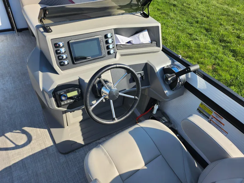 Slide: The Image of 2024 Qwest Angler Qwest XRE boat dashboard with steering wheel and control panel. - 22