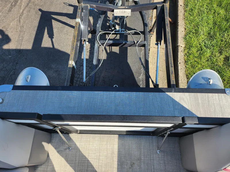 Slide: The Image of 2024 Qwest Angler Qwest XRE boat trailer view from above, parked on pavement. - 24