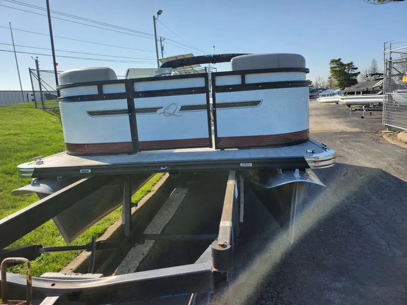 Slide: The Image of 2024 Qwest Angler Qwest XRE pontoon boat on trailer, parked outdoors. - 7