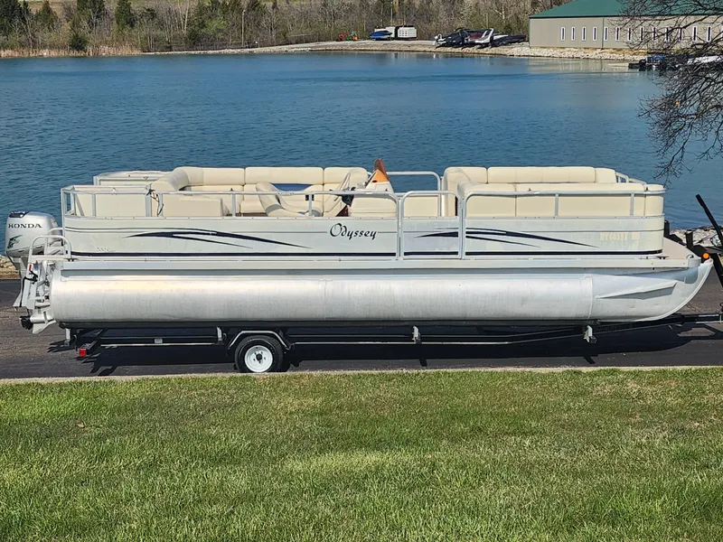 Slide: The Image of 2007 Odyssey Pontoons 222C on trailer by a lake, ready for water adventures. - 0