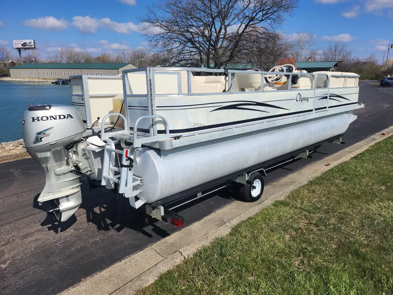 Slide: The Image of 2007 Odyssey Pontoons 222C boat with Honda motor on a trailer by a lake. - 1