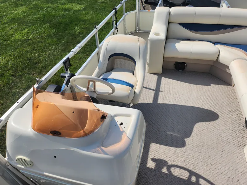 Slide: The Image of 2007 Odyssey Pontoons 222C interior with helm, seating, and carpeted deck. - 13