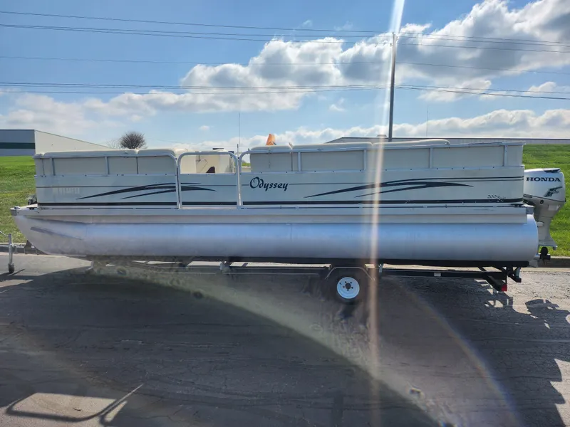 Slide: The Image of 2007 Odyssey Pontoons 222C pontoon boat on trailer under a sunny sky. - 4