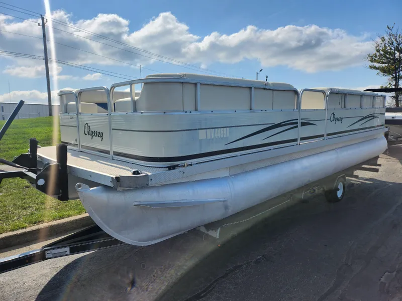 Slide: The Image of 2007 Odyssey Pontoons 222C on trailer under a clear blue sky. - 5