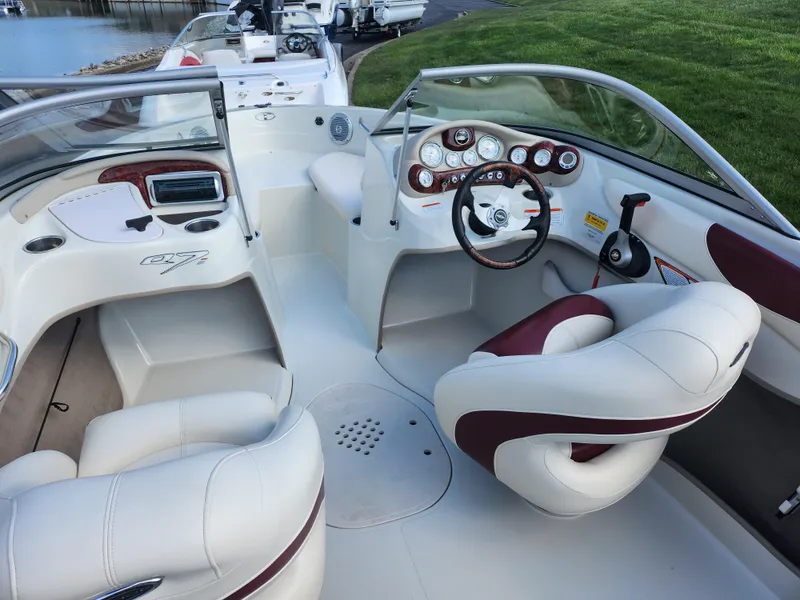 Slide: The Image of 2013 Tahoe Q7i boat interior with white and maroon seating, steering wheel, and dashboard controls. - 11