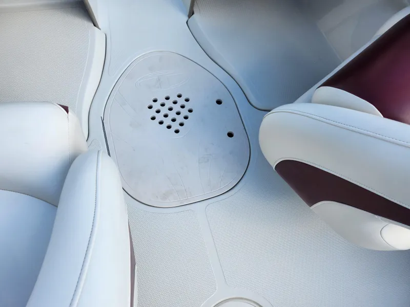 Slide: The Image of Interior seating of a 2013 Tahoe Q7i boat with white and maroon upholstery. - 12