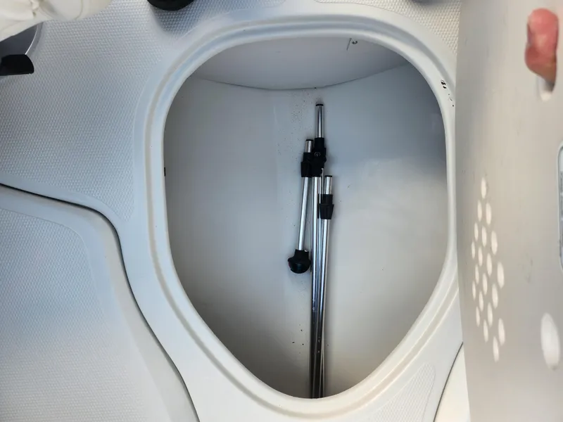 Slide: The Image of Storage compartment in a 2013 Tahoe Q7i boat with metal poles inside. - 13