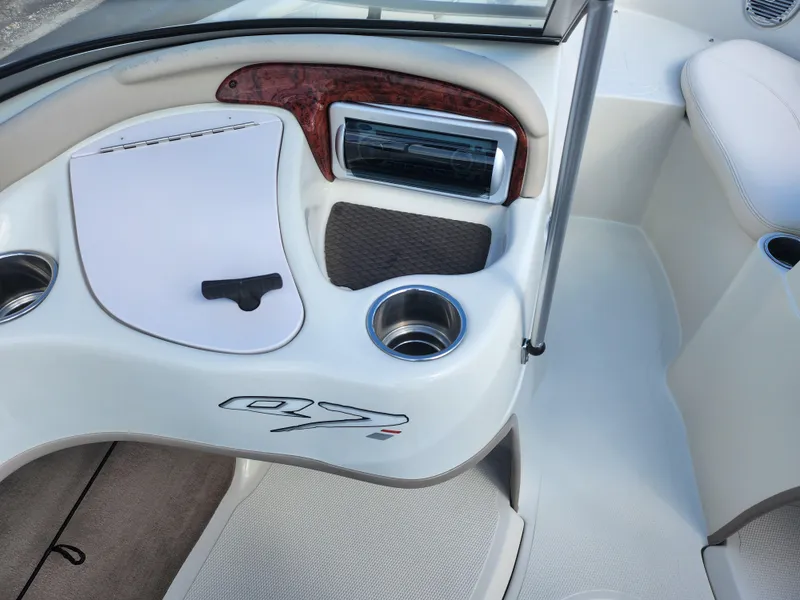 Slide: The Image of 2013 Tahoe Q7i boat interior with cup holders and dashboard details. - 16