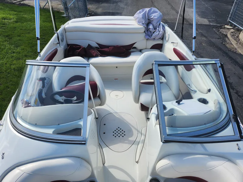 Slide: The Image of 2013 Tahoe Q7i boat interior with white and red seating, open bow design. - 21