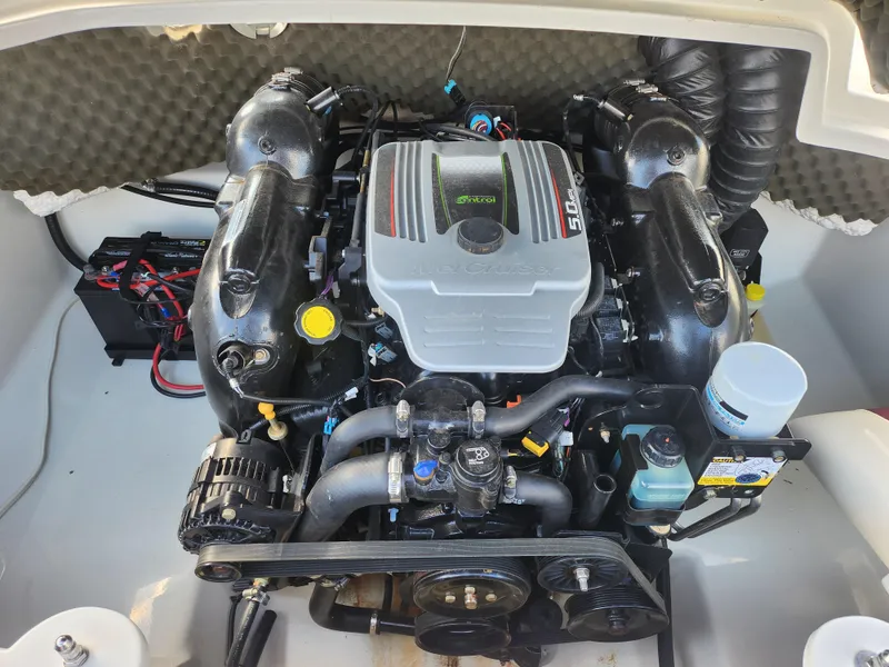 Slide: The Image of Engine compartment of a 2013 Tahoe Q7i boat, showcasing a well-maintained motor. - 25