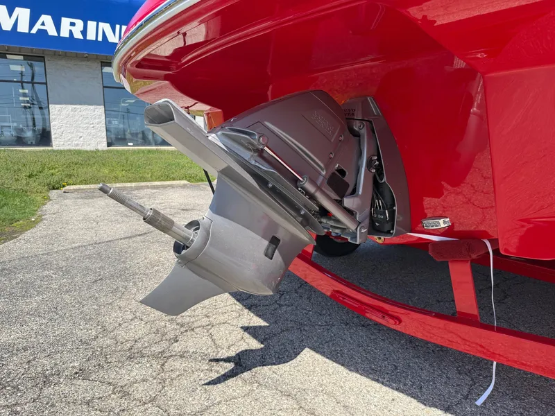 Slide: The Image of 2025 Crownline Eclipse E235 boat's outboard motor in a marina setting. - 11