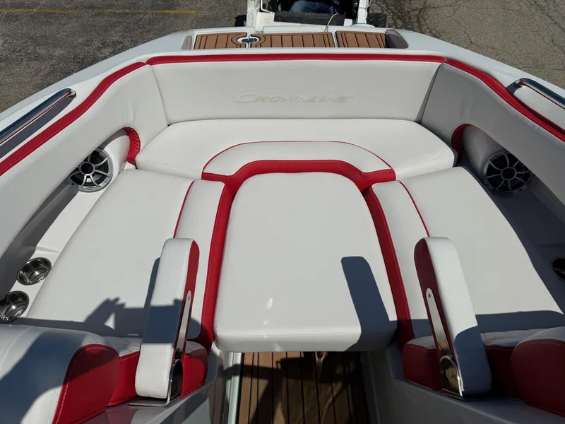 Slide: The Image of 2025 Crownline Eclipse E235 boat interior with red and white seating and speakers. - 4