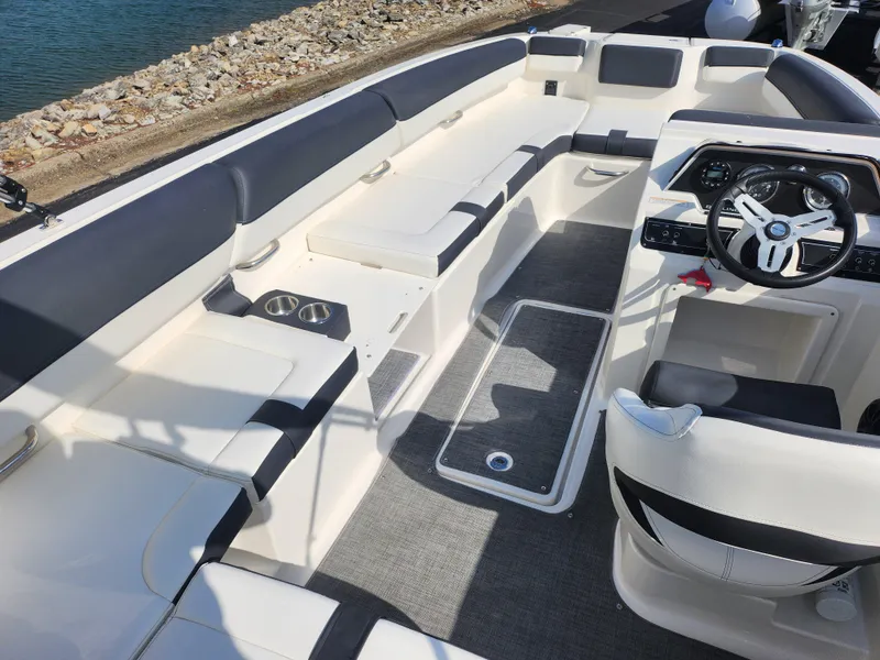 Slide: The Image of Interior of 2021 Bayliner DX 2000 boat with spacious seating and modern steering console. - 13