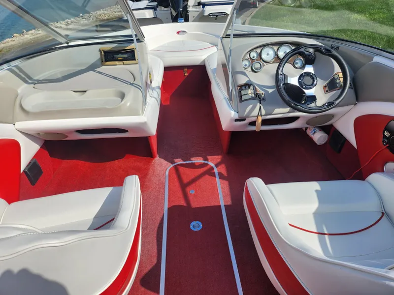 Slide: The Image of 1997 Bayliner 2050 Capri SS boat interior with red carpet and white seating. - 11