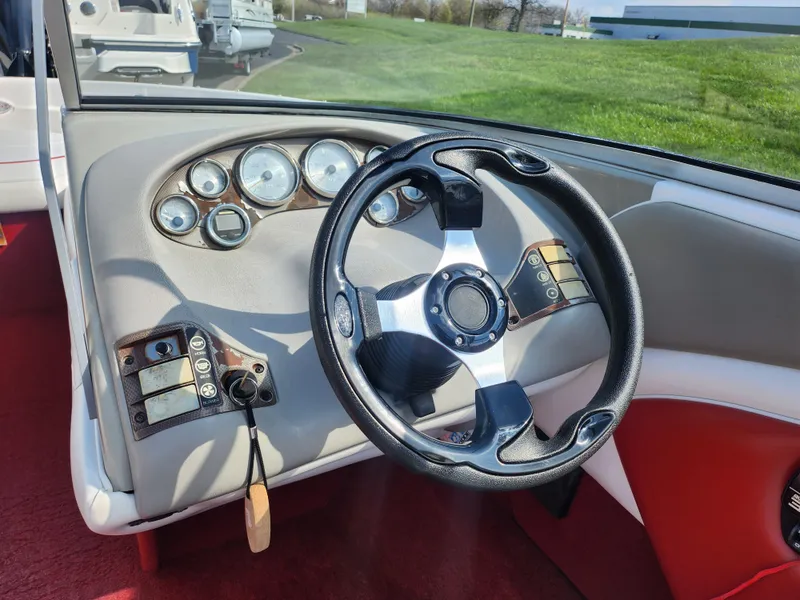 Slide: The Image of 1997 Bayliner 2050 Capri SS dashboard with steering wheel and gauges. - 12