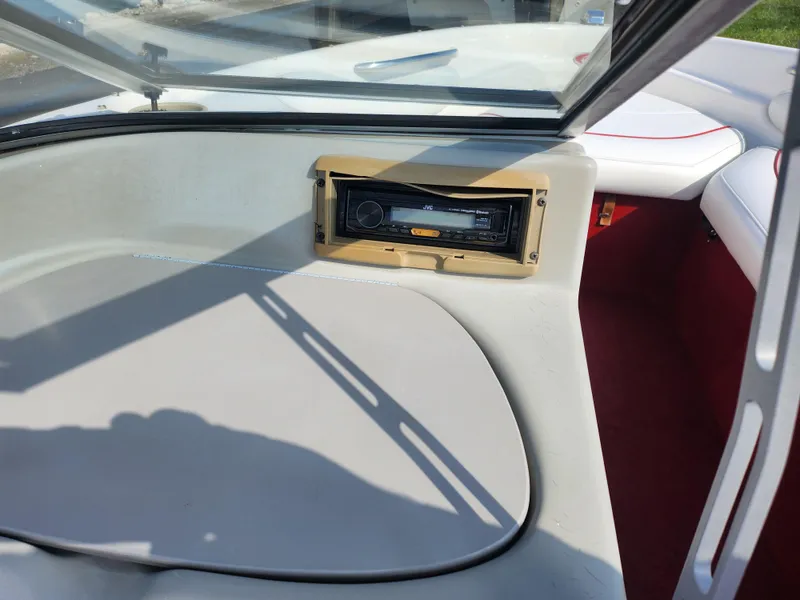 Slide: The Image of 1997 Bayliner 2050 Capri SS boat interior with stereo system and seating. - 13