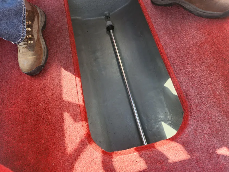 Slide: The Image of Red carpeted interior of a 1997 Bayliner 2050 Capri SS boat. - 14