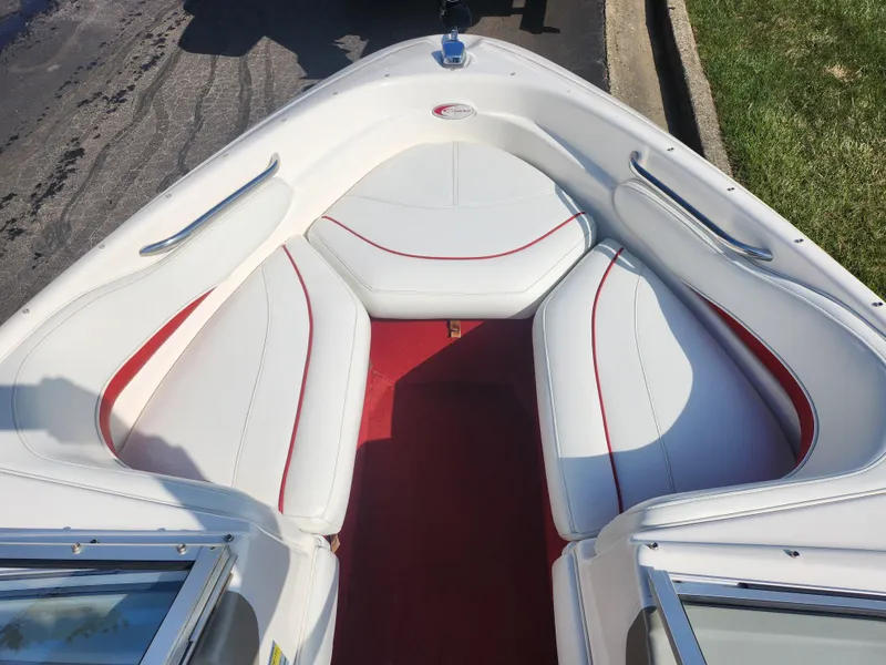 Slide: The Image of 1997 Bayliner 2050 Capri SS boat interior with white and red seating. - 16