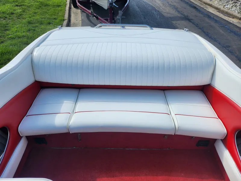 Slide: The Image of 1997 Bayliner 2050 Capri SS boat interior with white and red seating. - 20