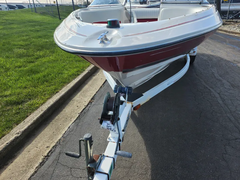 Slide: The Image of 1997 Bayliner 2050 Capri SS boat on trailer, parked on paved road. - 6
