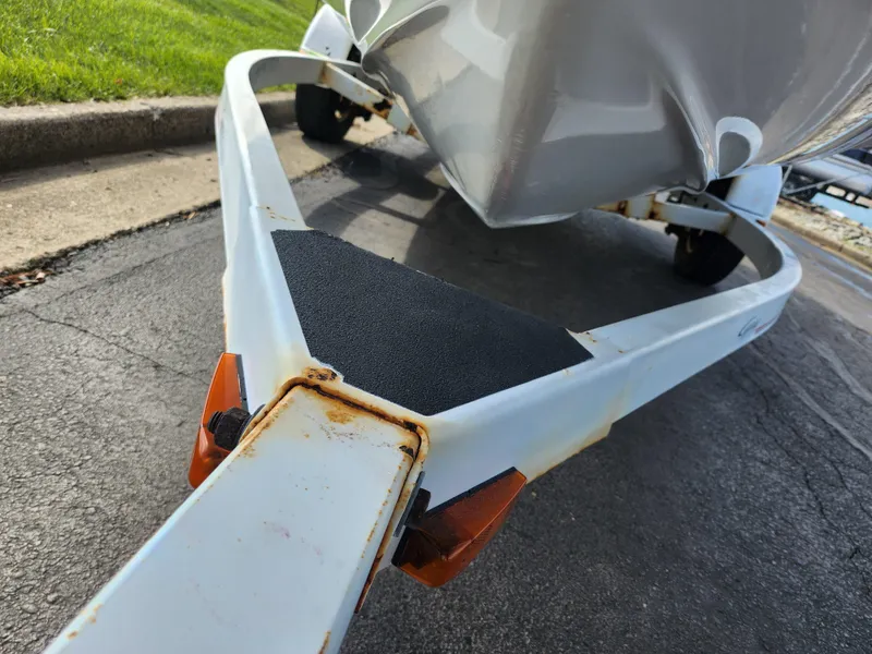 Slide: The Image of Trailer for 1997 Bayliner 2050 Capri SS boat, showing rust and wear on metal frame. - 7