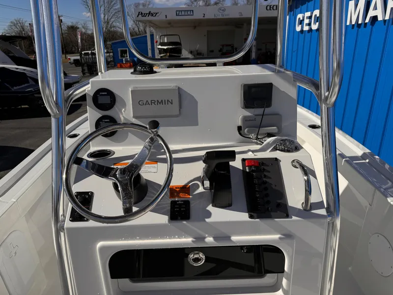Slide: The Image of 2025 Parker 18SE Center Console boat dashboard with Garmin navigation system and steering wheel. - 10