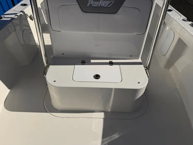 Slide: The Image of 2025 Parker 18SE Center Console boat interior, featuring sleek white seating and storage. - 14