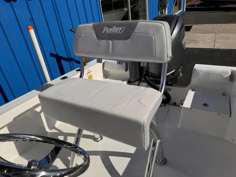 Slide: The Image of 2025 Parker 18SE Center Console boat interior with steering wheel and seating. - 18